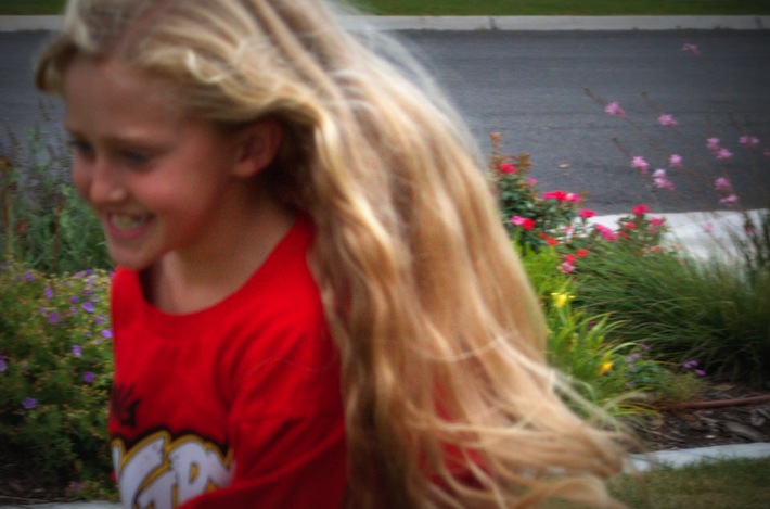 little girl with long hair running