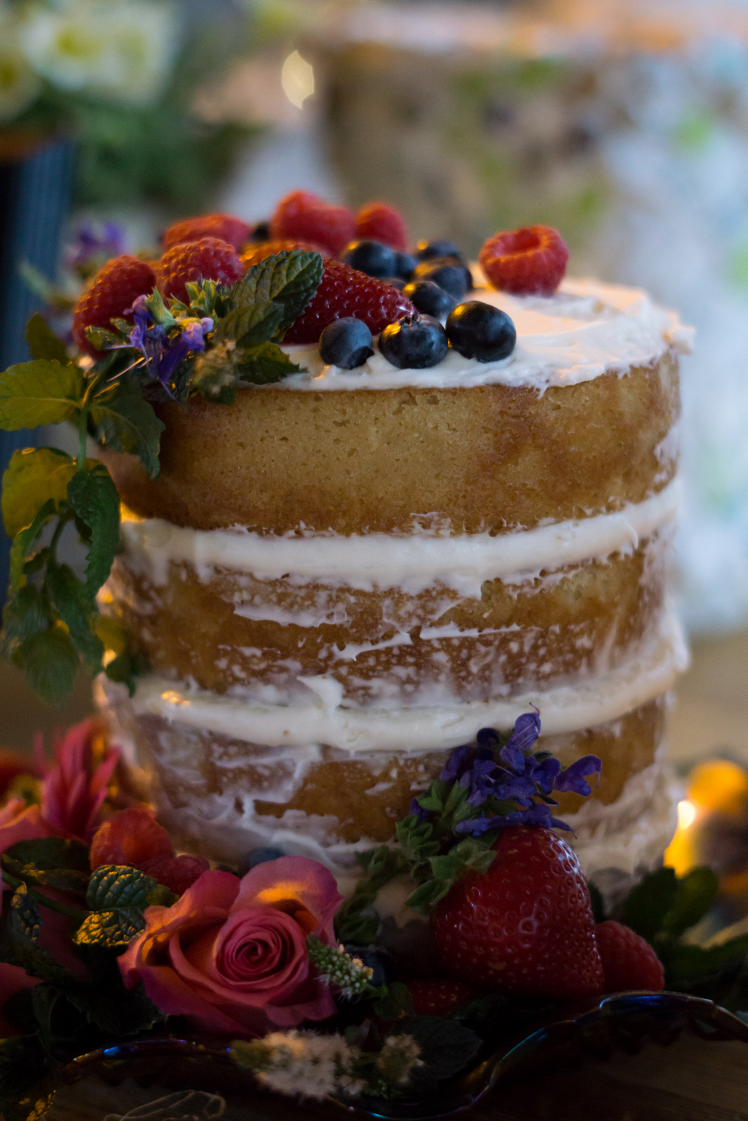 naked wedding cake with fruit and flowers